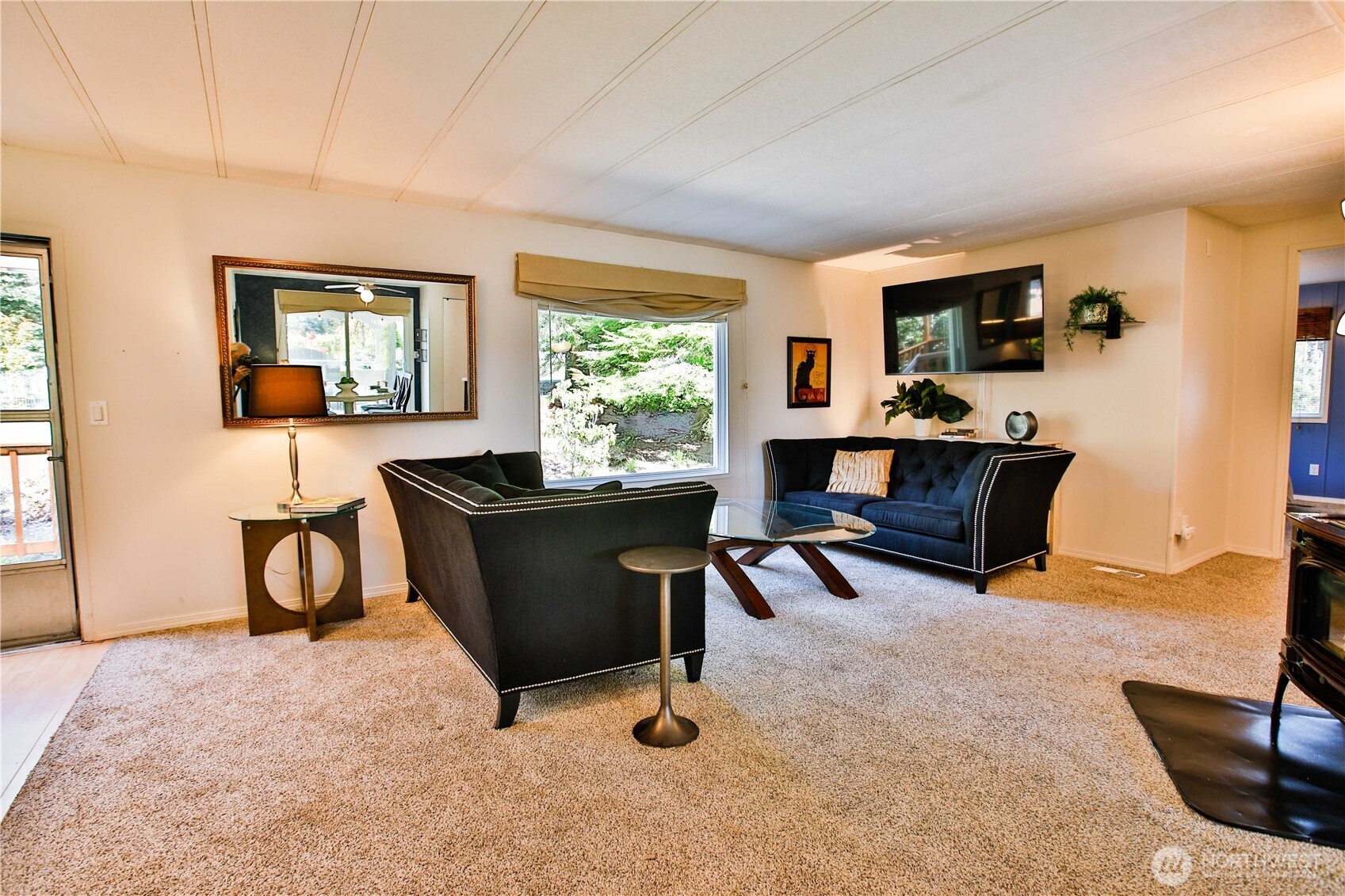 3276 East Harbor Road Langley, WA 98260 - Photo 19 of 37 a living room with furniture and a window