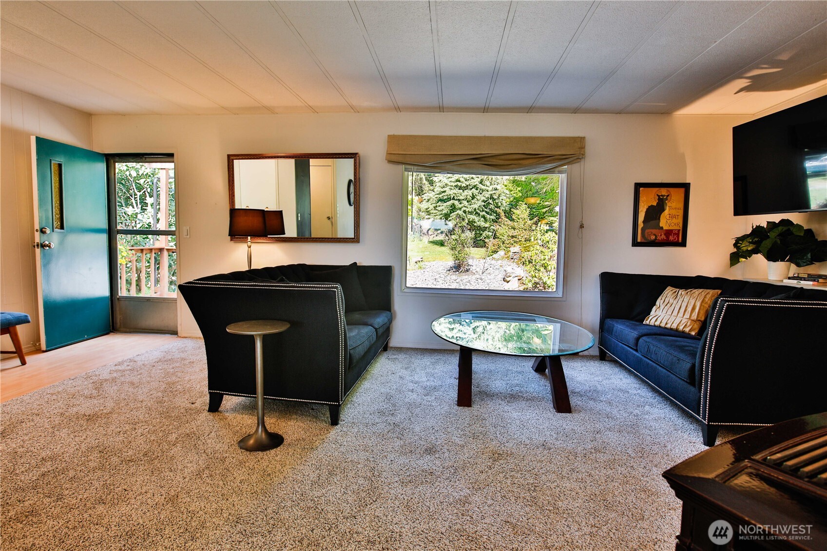 3276 East Harbor Road Langley, WA 98260 - Photo 20 of 37 a living room with furniture a window and a flat screen tv