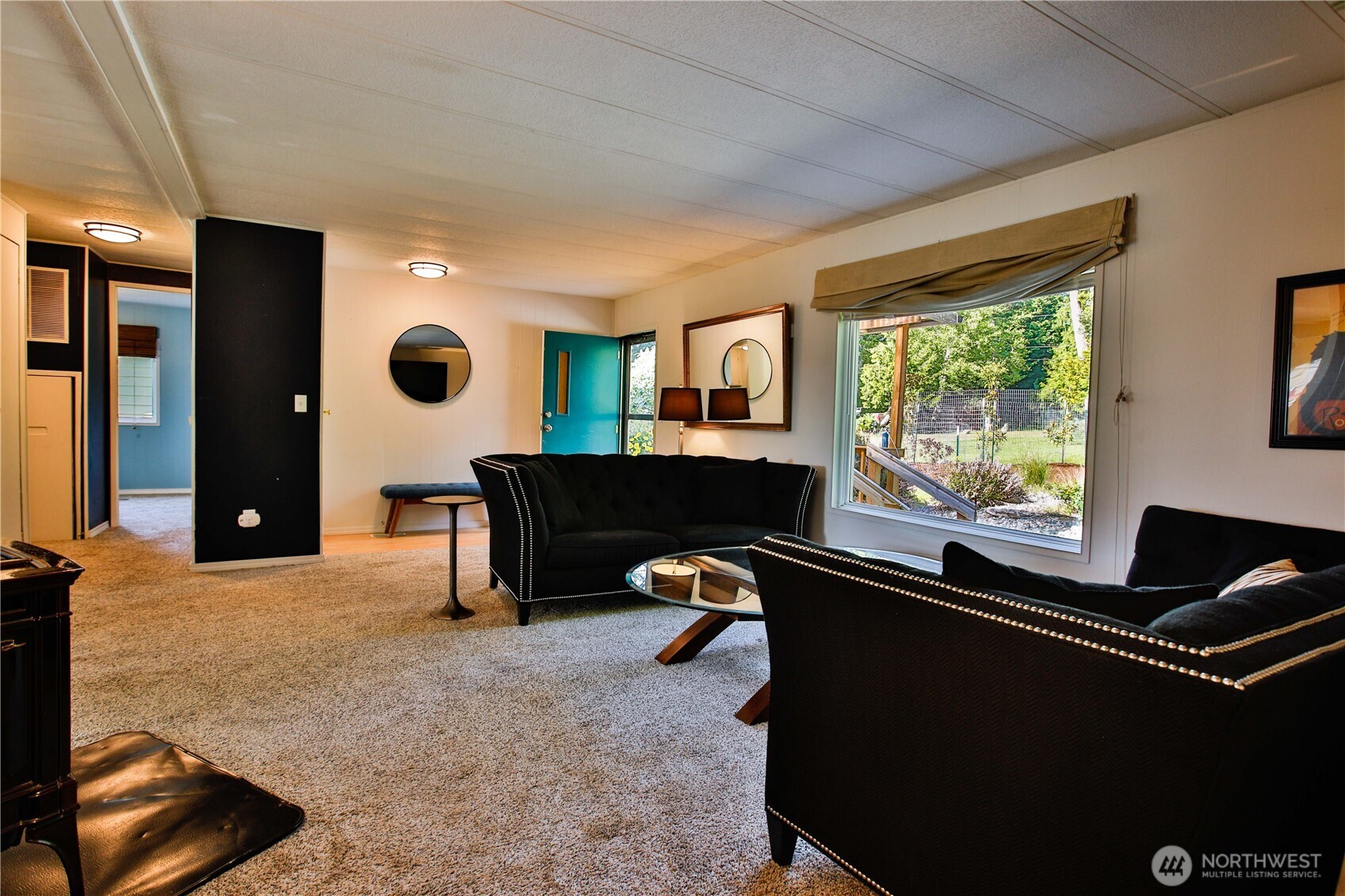 3276 East Harbor Road Langley, WA 98260 - Photo 26 of 37 a living room with furniture and a flat screen tv