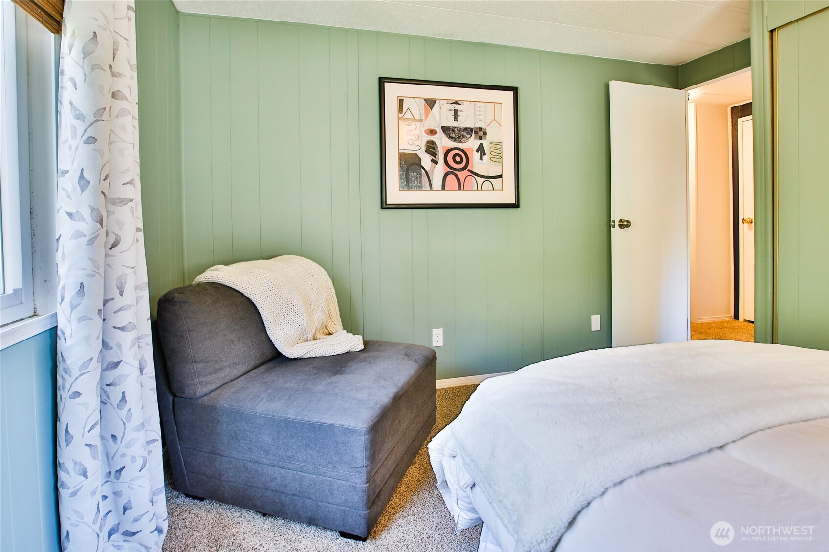 3276 East Harbor Road Langley, WA 98260 - Photo 30 of 37 a bedroom with a bed and a painting on the wall