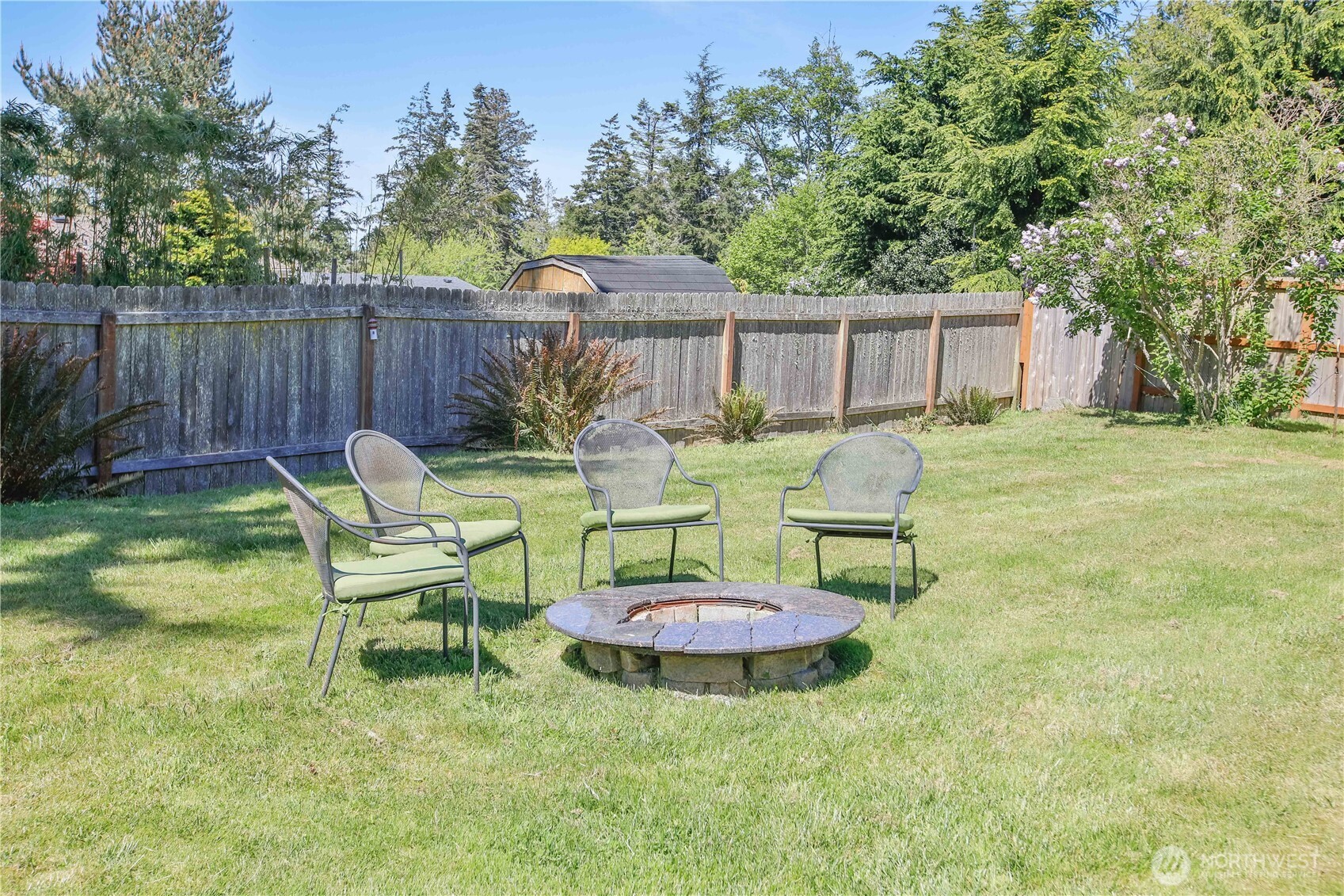 3276 East Harbor Road Langley, WA 98260 - Photo 31 of 37 a view of a chairs and table in backyard of the house