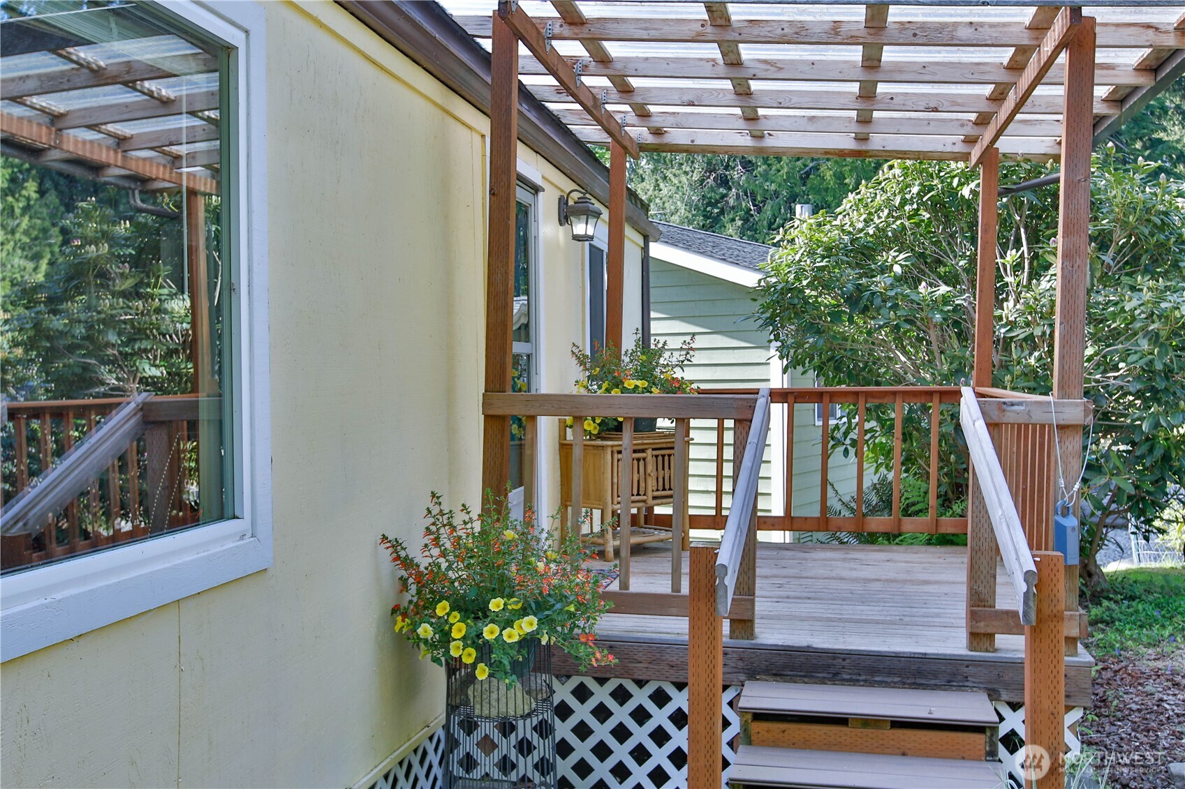 3276 East Harbor Road Langley, WA 98260 - Photo 5 of 37 a view of a house with large windows and plants