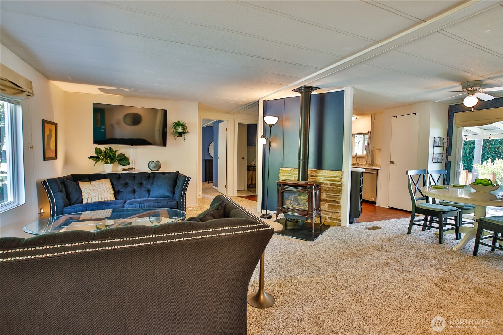 3276 East Harbor Road Langley, WA 98260 - Photo 7 of 37 a living room with furniture a flat screen tv and large window