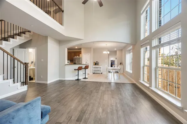 a view of a living room and dining room with wooden floor