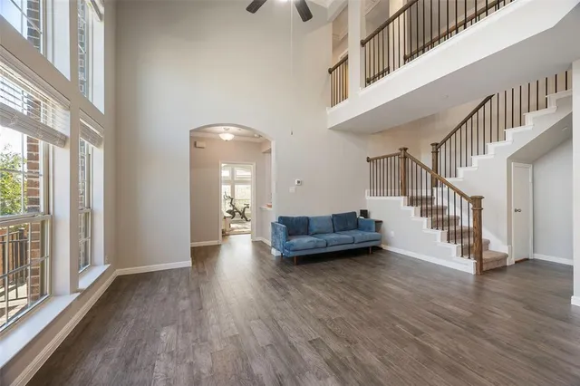 a view of a livingroom with wooden floor and stairs