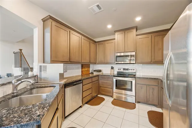 a kitchen with a sink stove and cabinets
