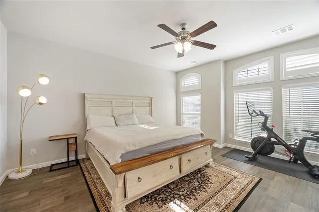 a bed room with a bed and wooden floor