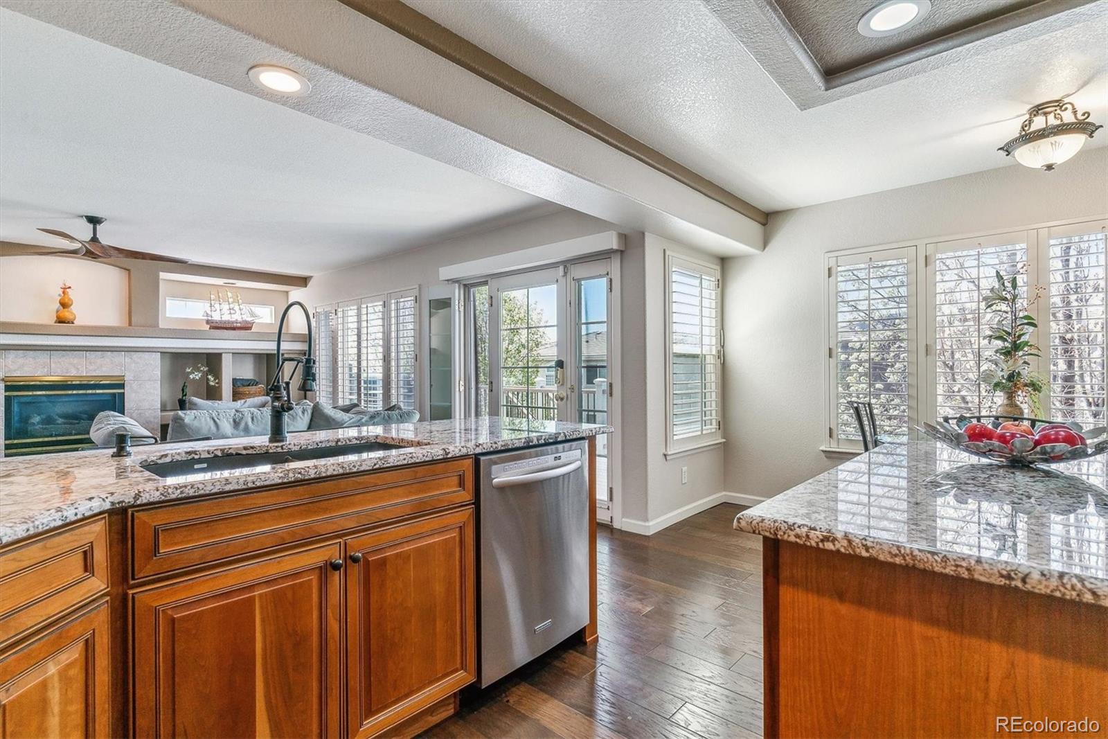 9109 South Ironwood Way Highlands Ranch, CO 80129 - Photo 11 of 49 a kitchen with sink and view of living room