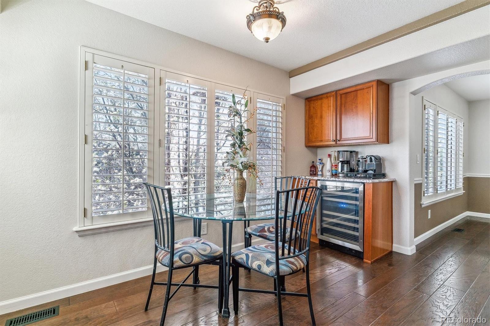 9109 South Ironwood Way Highlands Ranch, CO 80129 - Photo 14 of 49 a view of a dining room with furniture window and wooden floor