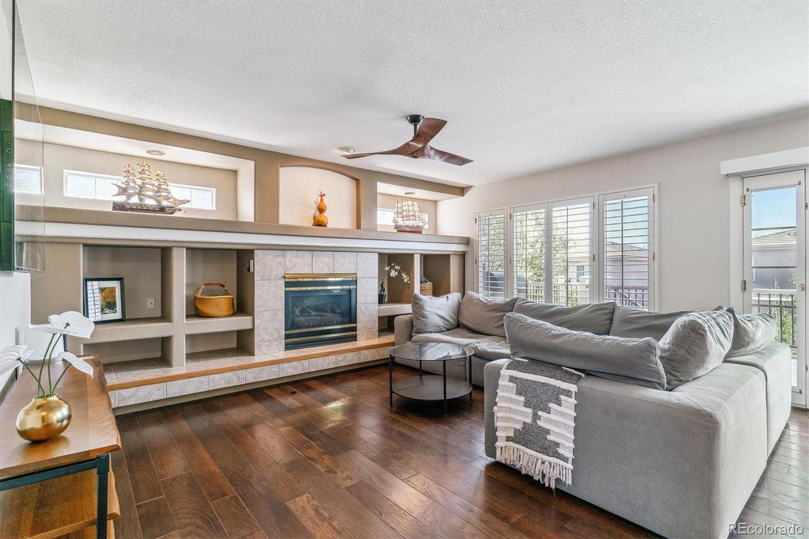 9109 South Ironwood Way Highlands Ranch, CO 80129 - Photo 17 of 49 a living room with furniture window and a fireplace