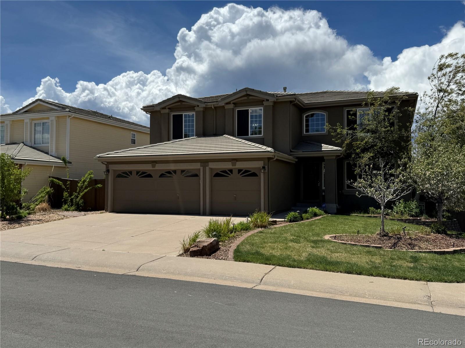 9109 South Ironwood Way Highlands Ranch, CO 80129 - Photo 2 of 49 a front view of a house with a yard