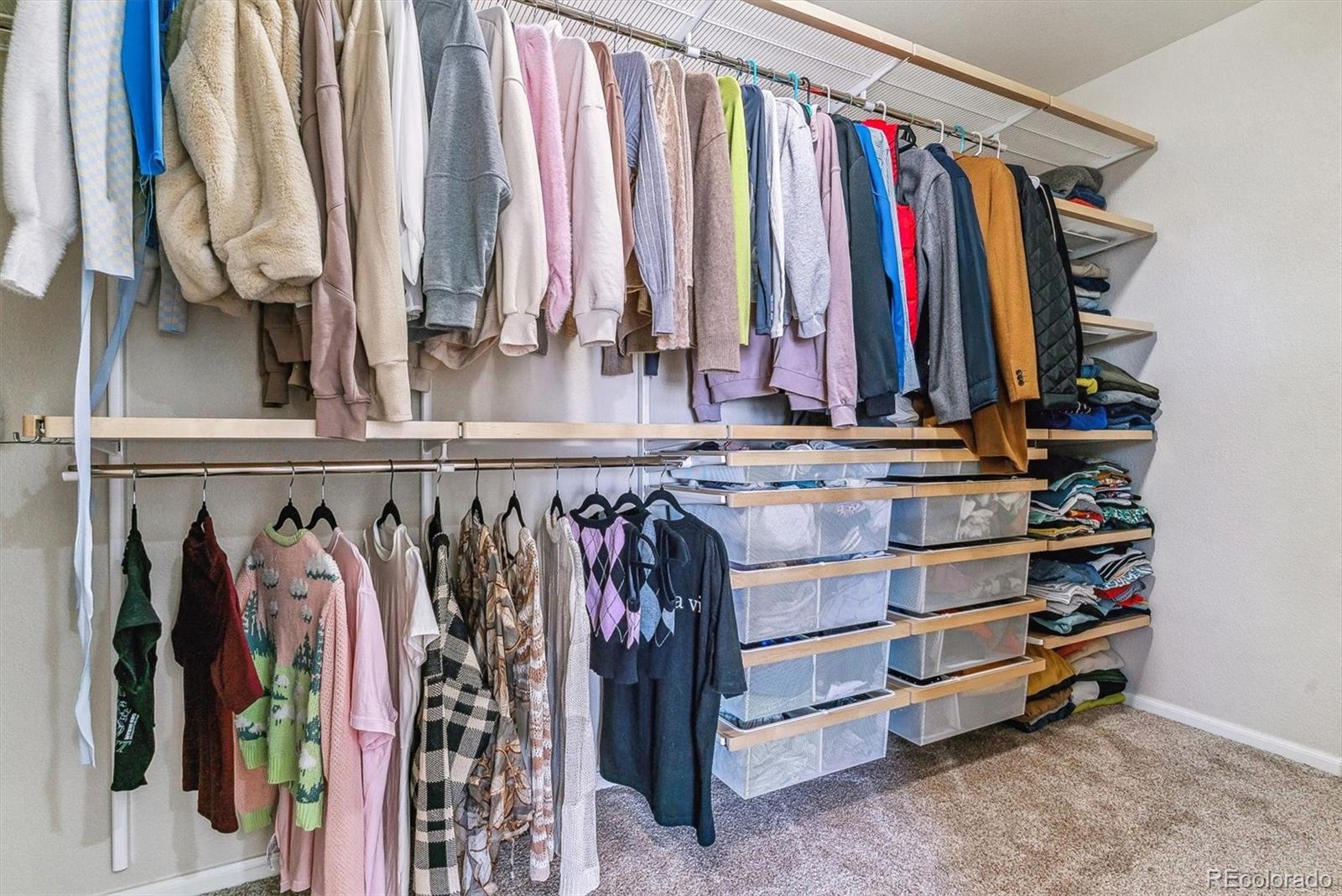 9109 South Ironwood Way Highlands Ranch, CO 80129 - Photo 29 of 49 a view of walk in closet with clothes
