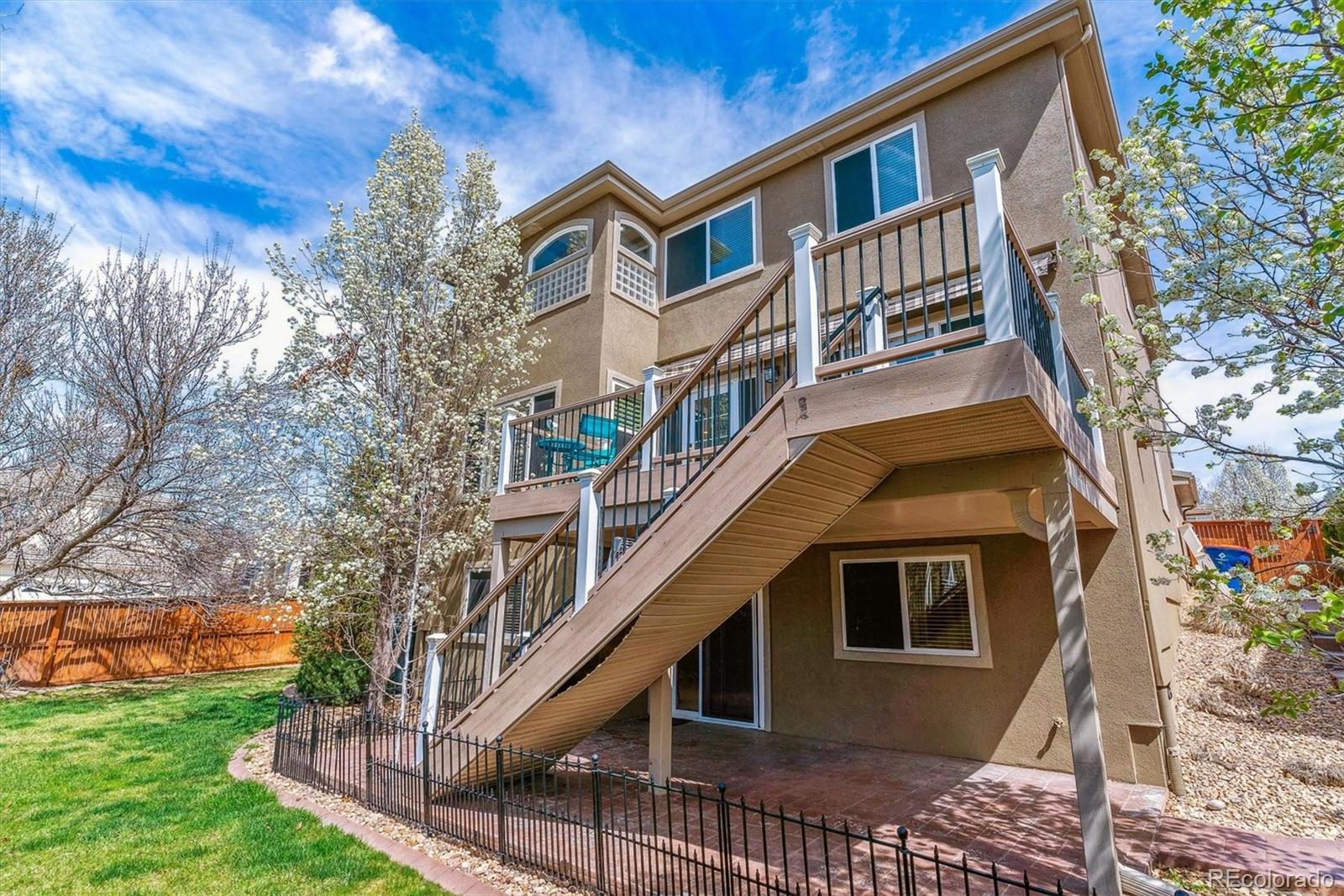 9109 South Ironwood Way Highlands Ranch, CO 80129 - Photo 5 of 49 a front view of a house with a yard