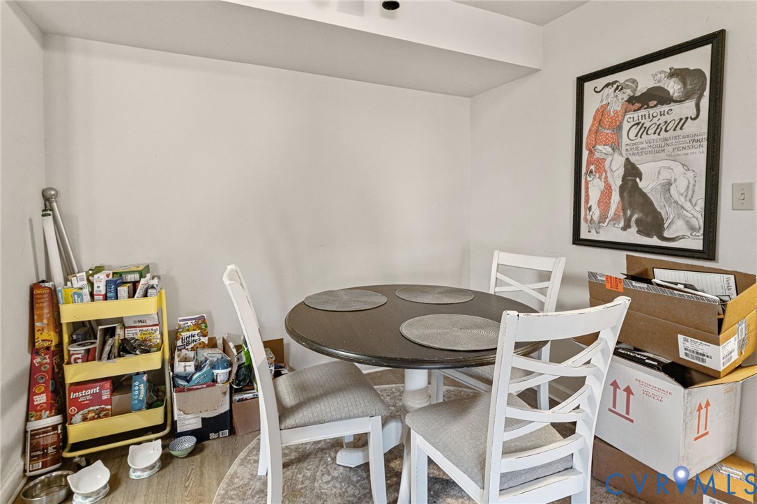 724 Bristol Village Drive, Unit 303 Midlothian, VA 23114 - Photo 13 of 14 a dining room with furniture and wooden floor