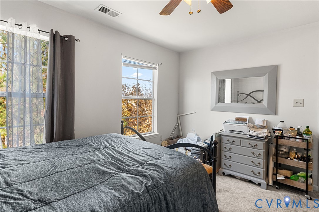 724 Bristol Village Drive, Unit 303 Midlothian, VA 23114 - Photo 6 of 14 a bedroom with a bed and a dresser