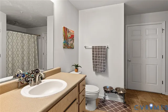 a living room with furniture kitchen view and a large window