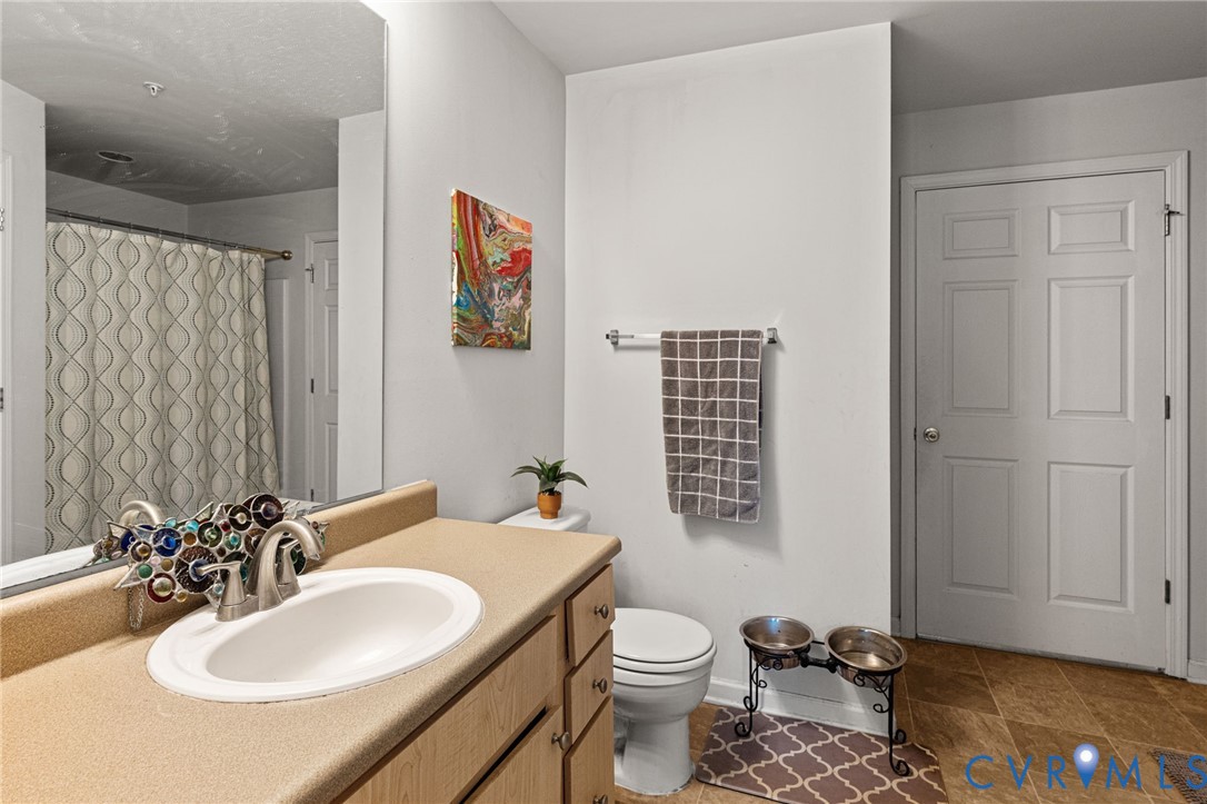 724 Bristol Village Drive, Unit 303 Midlothian, VA 23114 - Photo 7 of 14 a bathroom with a sink toilet and shower