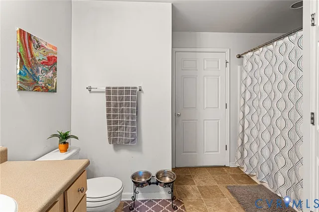 a kitchen with a table chairs sink and cabinets