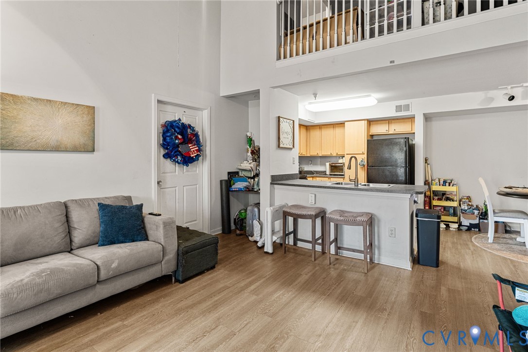 724 Bristol Village Drive, Unit 303 Midlothian, VA 23114 - Photo 9 of 14 a living room with furniture kitchen view and a large window