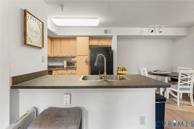 a kitchen with a refrigerator stove and cabinets