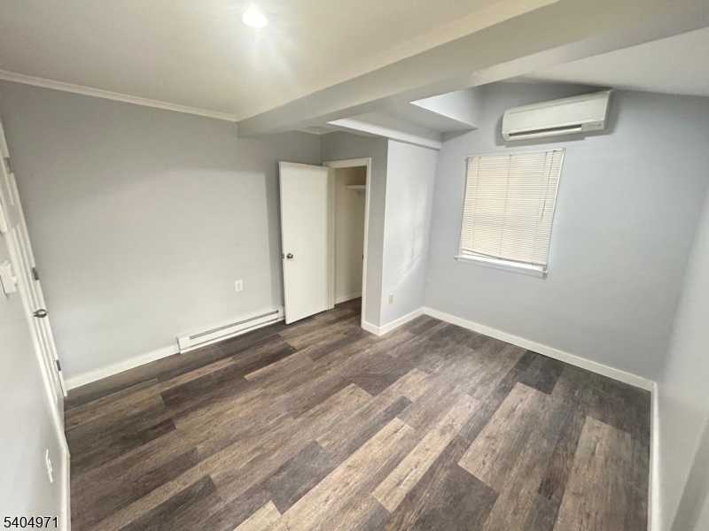 38 West River Styx Road Hopatcong, NJ 07843 - Photo 12 of 36 an empty room with wooden floor cabinet and windows