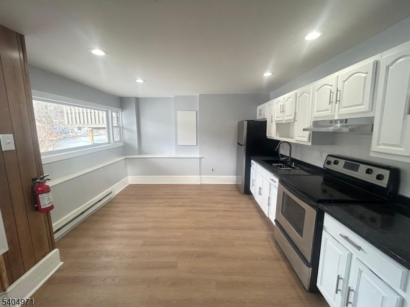 38 West River Styx Road Hopatcong, NJ 07843 - Photo 18 of 36 a large kitchen with stainless steel appliances granite countertop a stove and a refrigerator