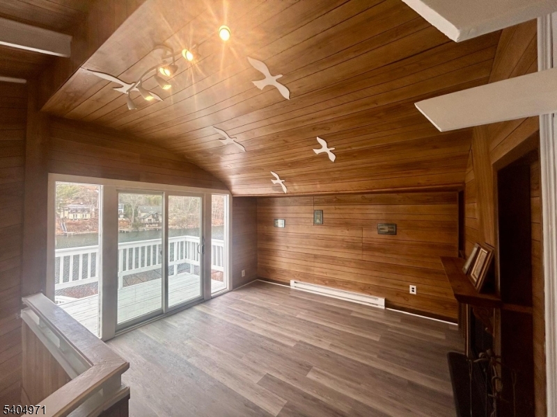 38 West River Styx Road Hopatcong, NJ 07843 - Photo 6 of 36 a view of an empty room with wooden floor and a window