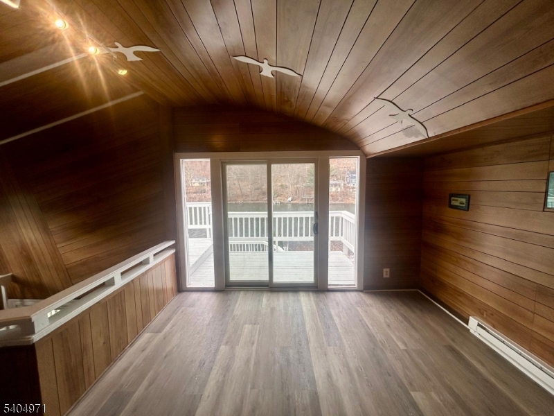 38 West River Styx Road Hopatcong, NJ 07843 - Photo 7 of 36 a view of an empty room with wooden floor and a window