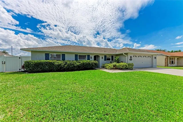 a view of house with yard and green space