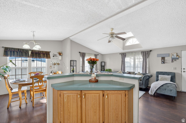 269 Mindella Way, Unit A Layton, UT 84041 - Photo 37 of 37 Kitchen with open floor plan, a kitchen island, dark wood finished floors, a ceiling fan, and a chandelier