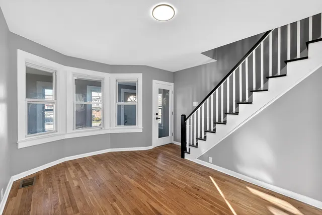 a view of an entryway with wooden floor and stairs
