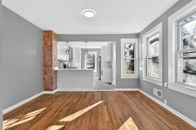 a view of a living room and wooden floor