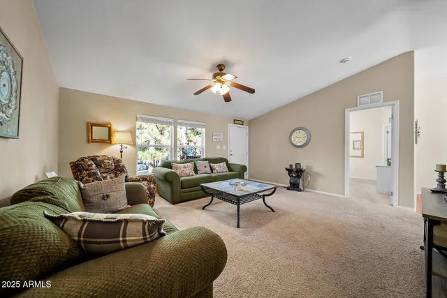 a kitchen with stainless steel appliances granite countertop a stove a refrigerator a oven a sink with a dining table and chairs