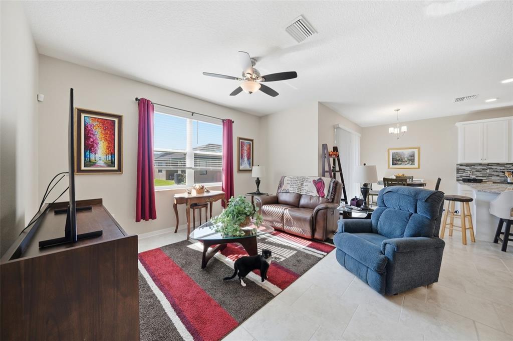 220 Hillshire Place Spring Hill, FL 34609 - Photo 11 of 18 a living room with furniture fireplace and a large window