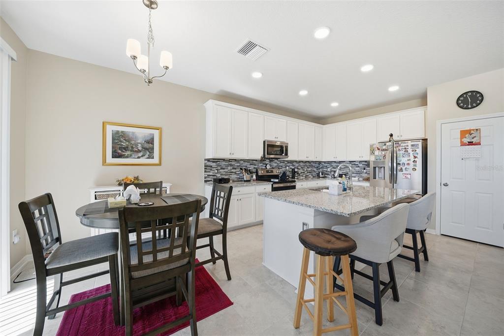220 Hillshire Place Spring Hill, FL 34609 - Photo 13 of 18 a view of a dining room with furniture and wooden floor