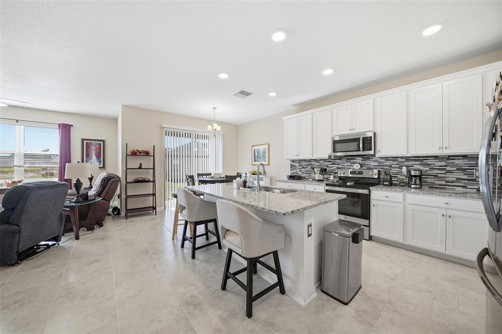 220 Hillshire Place Spring Hill, FL 34609 - Photo 14 of 18 a kitchen with cabinets a sink and chairs