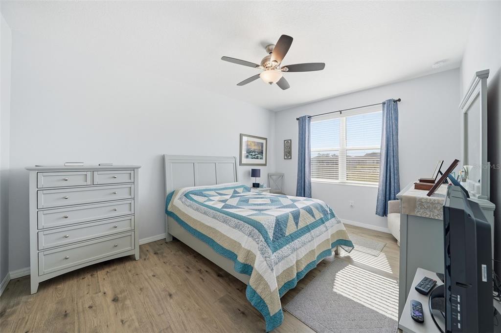 220 Hillshire Place Spring Hill, FL 34609 - Photo 15 of 18 a bedroom with a bed and a chandelier