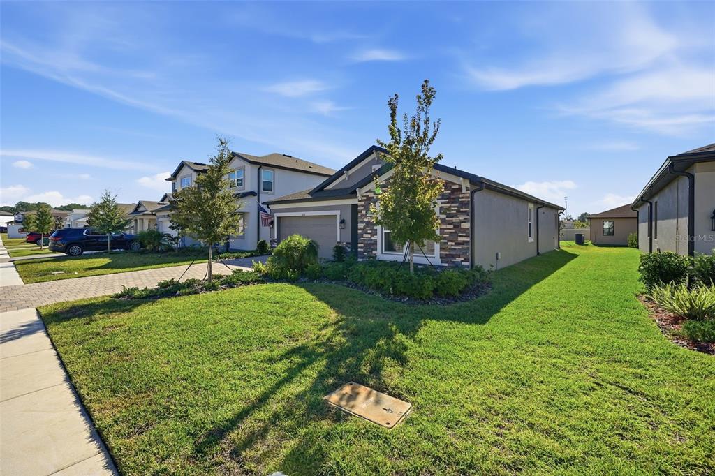 220 Hillshire Place Spring Hill, FL 34609 - Photo 2 of 18 a front view of a house with garden