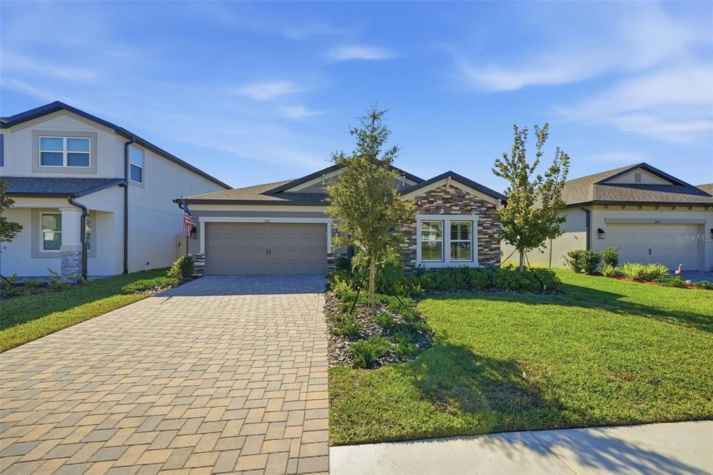 220 Hillshire Place Spring Hill, FL 34609 - Photo 3 of 18 a front view of a house with garden