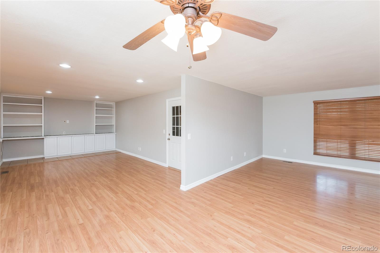 11103 Eudora Circle Thornton, CO 80233 - Photo 3 of 17 a view of an empty room with wooden floor and a chandelier fan
