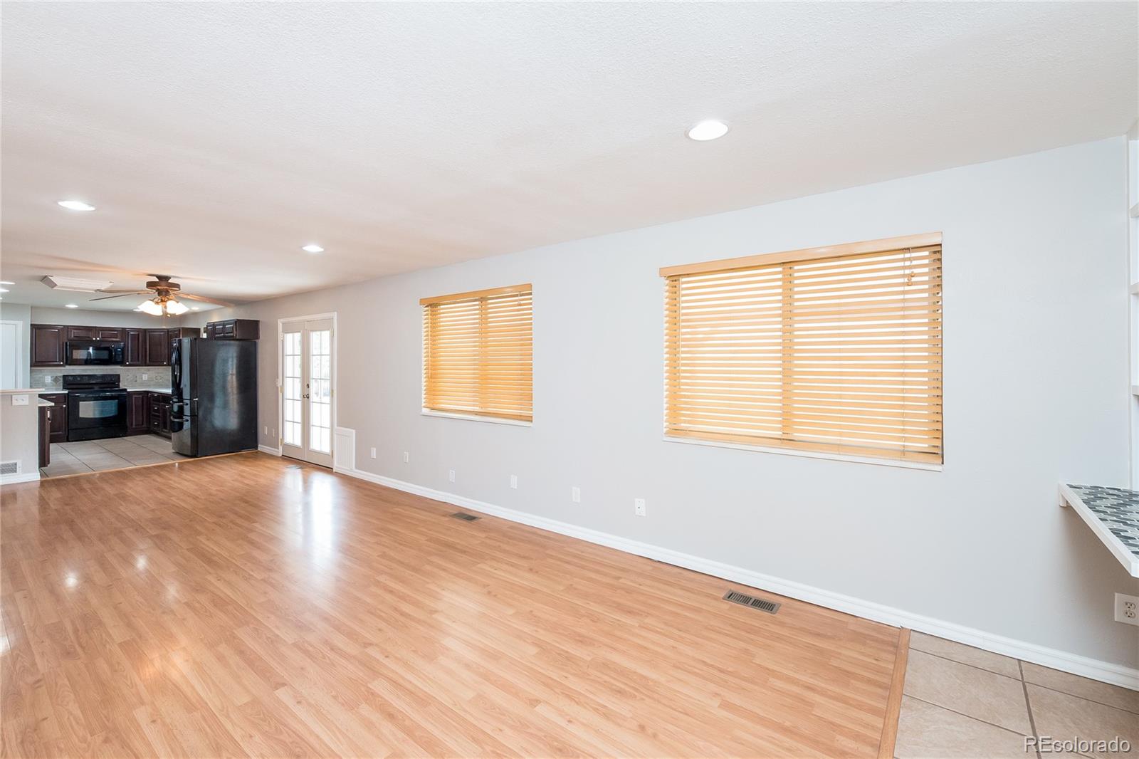 11103 Eudora Circle Thornton, CO 80233 - Photo 6 of 17 a view of an empty room with a window and a kitchen