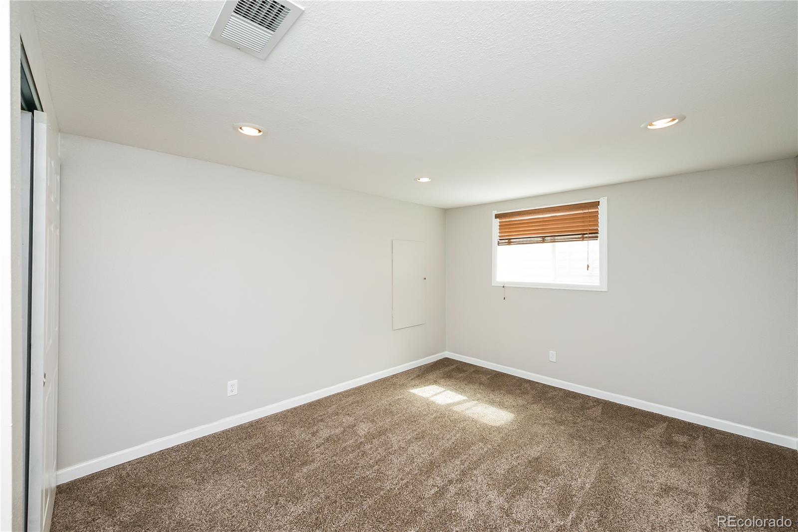 11103 Eudora Circle Thornton, CO 80233 - Photo 9 of 17 an empty room with a empty space and a window