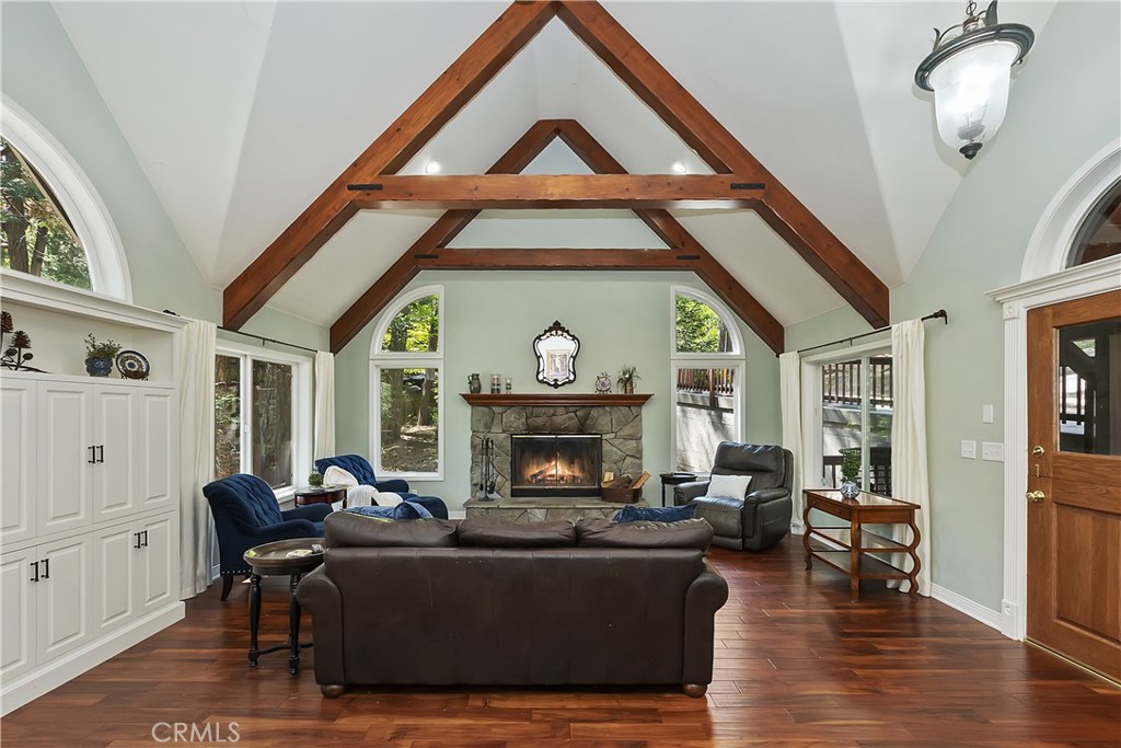 a living room with furniture a fireplace and a chandelier