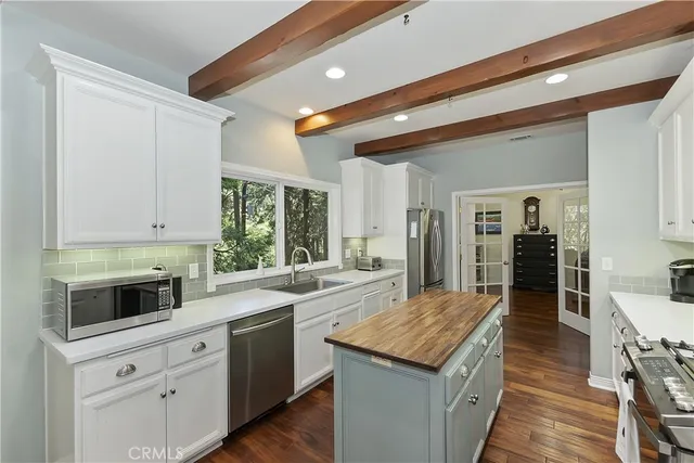 a kitchen with a stove sink and cabinets