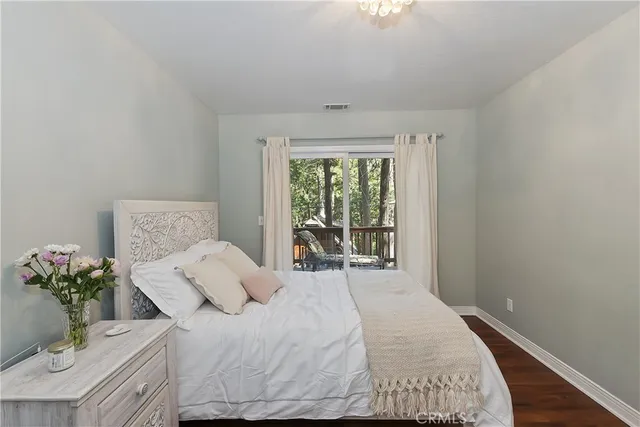 a bedroom with a bed and a potted plant