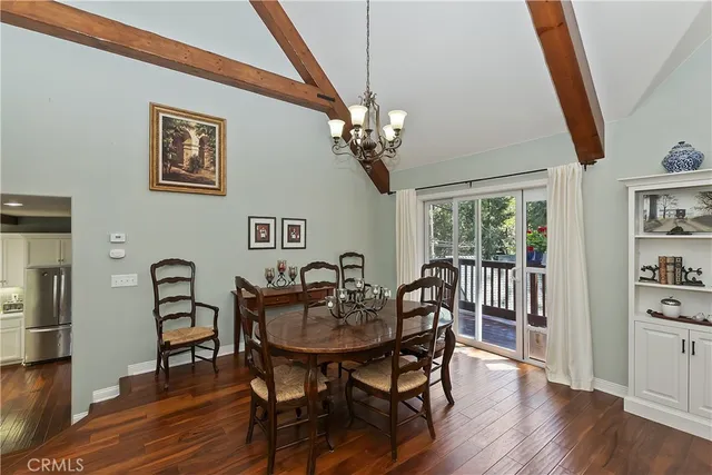 a view of a dining room with furniture wooden floor and a chandelier