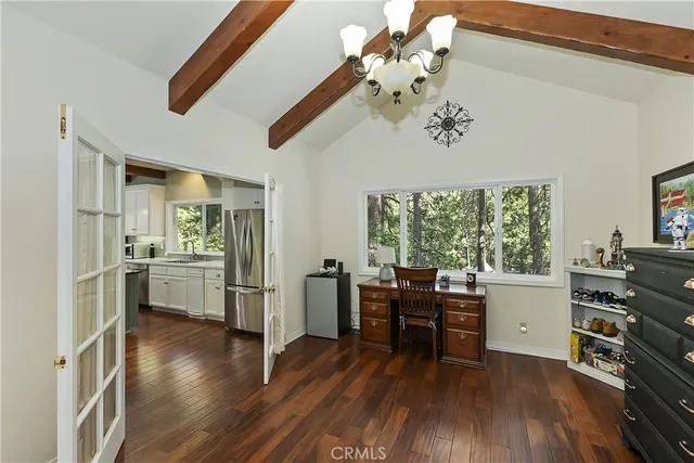 a view of a workspace with furniture and a window