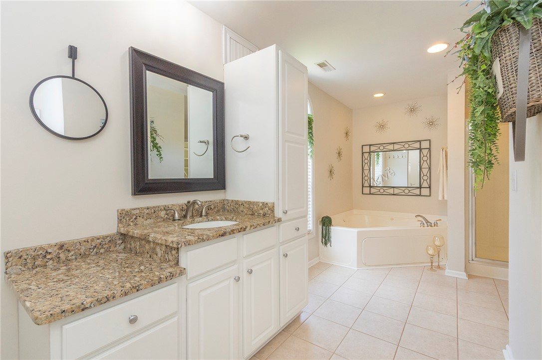 125 Inlet Pointe Drive Anderson, SC 29625 - Photo 23 of 39 Discover a tranquil primary bathroom with a spacious corner soaking tub and practical dual vanity.