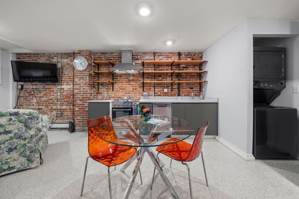 26 Unity Street, Unit 1 Boston, MA 02113 - Photo 12 of 27 a dinning room with furniture and a flat screen tv