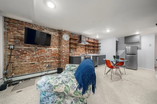 a living room with furniture fireplace and a large window